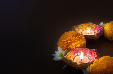 Diwali candles with marigold flowers creating a festive ambiance