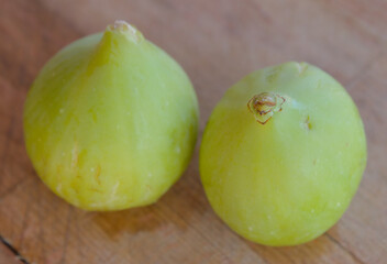Green figs on a wooden cutting board