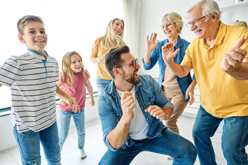 Portrait of a three generation famili, grandparents, parents and children playing and having fun...