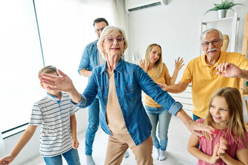 Portrait of a three generation famili, grandparents, parents and children playing and having fun...