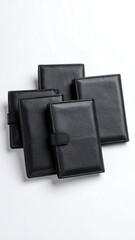 Stack of black leather-bound notebooks