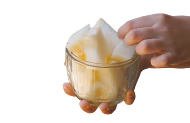 A melon cut into pieces in a crystal bowl in his hand on a white background