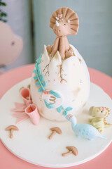 Elegant birthday cake with floral design and golden butterflies.