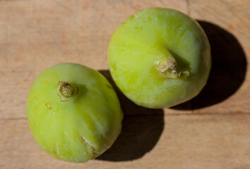 Green figs on a wooden cutting board
