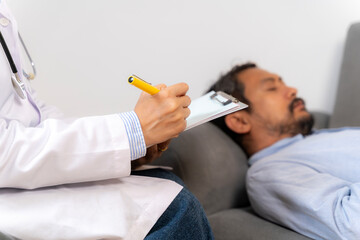 A young man consulting with a doctor for insomnia treatment, concept of healthcare, mental health,...