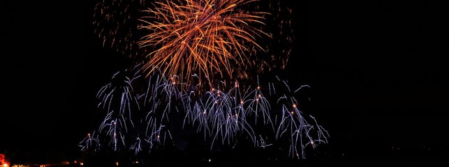 Fireworks show in the black sky. Flaming stars. Scharnhausen. Germany. Europe.