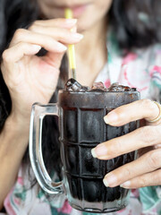 women drink Thai style ice black coffee