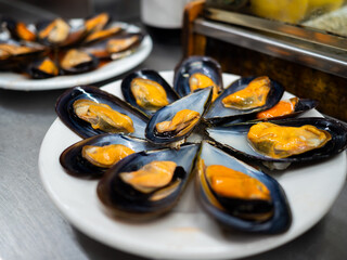 Plate of fresh mussels served on a dish in a restaurant