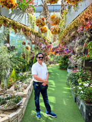 Handsome solo tourist posing in Floral Fantasy at garden by the bay in Singapore