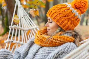 Peaceful Young Woman Relaxing in Hammock Amidst Autumn Leaves, Wearing Cozy Orange Knitwear