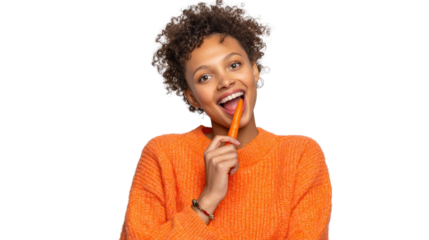 Smiling woman in an orange sweater enjoying a healthy snack against a white background.