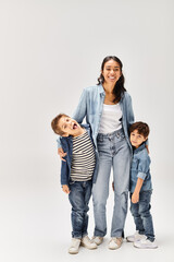 Fototapeta premium Joyful moments shared by a young mother and her playful sons in casual outfits
