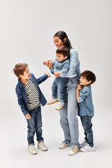Joyful moments of a young mother playing with her adorable children together