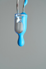 Cyan paint drop falling from led