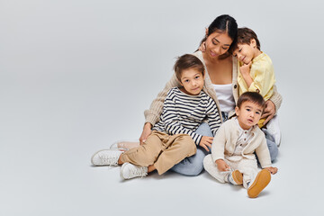 Mom and her adorable boys enjoying a loving moment together indoors