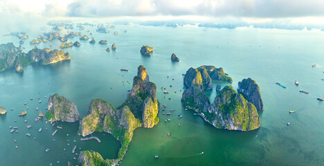 Aerial view floating fishing village and rock island, Halong Bay, Vietnam, Southeast Asia. UNESCO World Heritage Site. Junk boat cruise to Ha Long Bay. Popular landmark, famous destination of Vietnam © huythoai