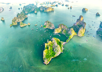 Aerial view floating fishing village and rock island, Halong Bay, Vietnam, Southeast Asia. UNESCO World Heritage Site. Junk boat cruise to Ha Long Bay. Popular landmark, famous destination of Vietnam © huythoai