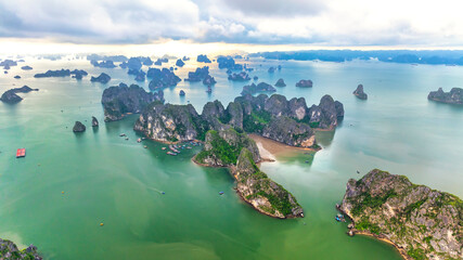 Aerial view floating fishing village and rock island, Halong Bay, Vietnam, Southeast Asia. UNESCO World Heritage Site. Junk boat cruise to Ha Long Bay. Popular landmark, famous destination of Vietnam © huythoai