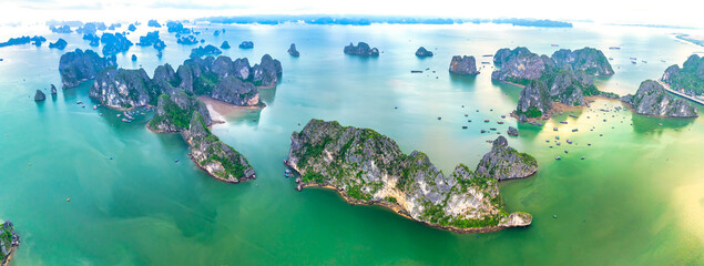 Aerial view floating fishing village and rock island, Halong Bay, Vietnam, Southeast Asia. UNESCO World Heritage Site. Junk boat cruise to Ha Long Bay. Popular landmark, famous destination of Vietnam © huythoai