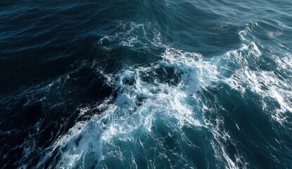 Bright sunlight reflects on the tranquil ocean as waves gently lap at the surface, creating a stunning interplay of blues and whites near the shoreline. The calmness of the scene evokes peace