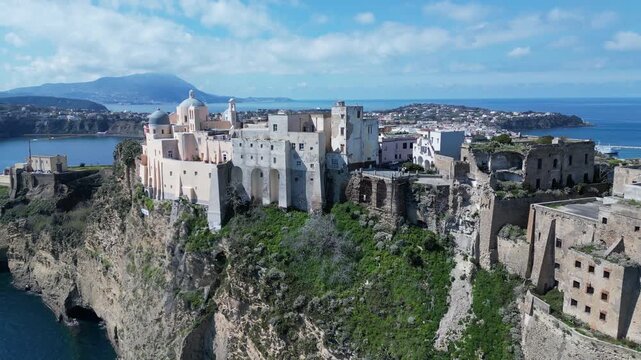 Aerial view of abbey (or church) of San Michele Arcangelo, located on sheer cliff on Procida, historic architecture and scenic landscape Italy Europe