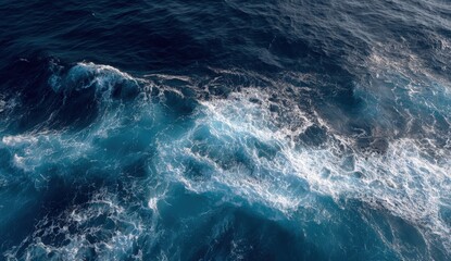 Bright sunlight reflects on the tranquil ocean as waves gently lap at the surface, creating a stunning interplay of blues and whites near the shoreline. The calmness of the scene evokes peace