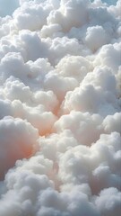 Beautiful white cumulus clouds are creating a breathtaking view in the vast expanse of the blue sky, illuminated by the warm glow of the sun