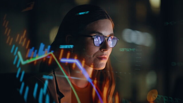 Stock market trader working hologram night closeup. Diagrams projected on face - Powered by Adobe
