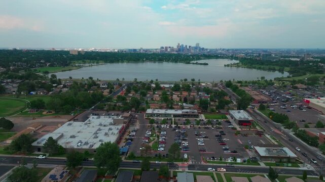 Summer at Sloans Lake Park downtown Denver spring Colorado aerial drone Edgewater Marketplace blue skies rain clouds cityscape skyscrapers neighborhood business Coflax Sherdian cars traffic forward