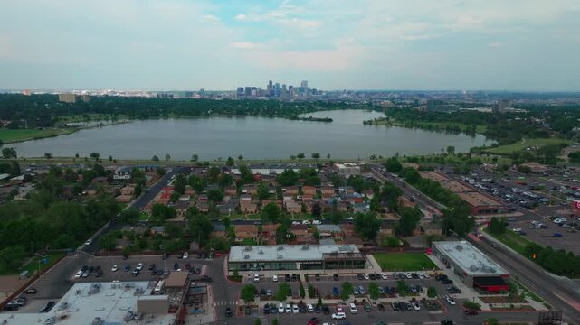 Summer at Edgewater Marketplace Sloans Lake Park downtown Denver spring Colorado aerial drone blue skies rain clouds cityscape skyscrapers neighborhood business Coflax Sherdian cars traffic upwards