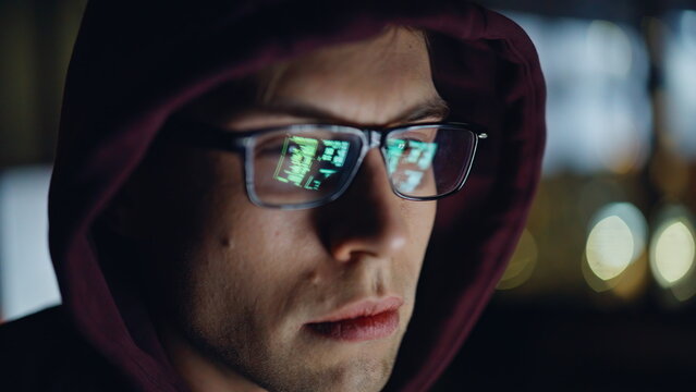 IT programer checking computer code eyeglasses reflection closeup. Late engineer