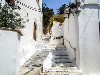 Quiet  streets lead down from ruins of Acropolis to the city centre in Lindos city on Rhodes island...
