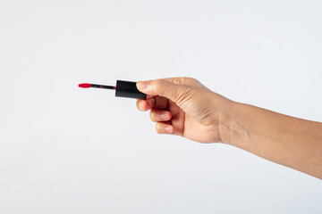 Black lipstick on hand on white background