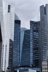 Striking modern skyscrapers with reflective glass facades dominate the urban skyline, showcasing contemporary architecture and city living.