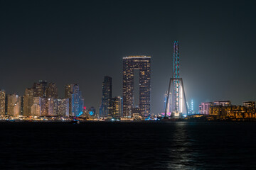 Dubai Marina skyline at night with Dubai Ain light show, view from Palm Jumeirah, Dubai luxury real...