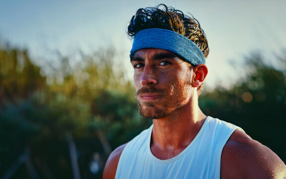 Portrait of young sportsman resting after training outside