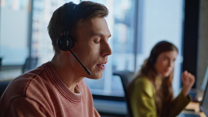 Emotional operator helping client office portrait. Assistants work call center