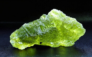 Vltavin, moldavite, natural green colored glass with a surface structure called sculpting.