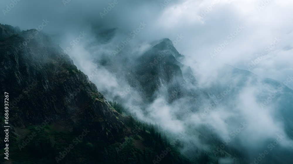 Poster majestic mountain range with sharp rocky cliffs partially obscured by ethereal mist and drifting clo