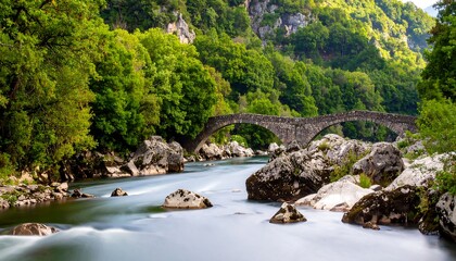 Mountain river and ancient stone arch bridge