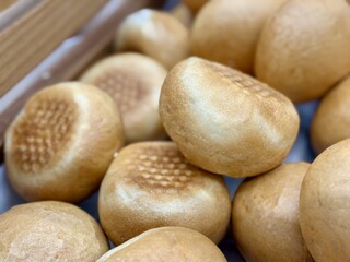 Freshly Baked Selection of Various Bread Rolls, Served Warm in Beautifully Attractive Basket. A closeup view showcasing a variety of delicious freshly baked bread rolls resting comfortably in basket