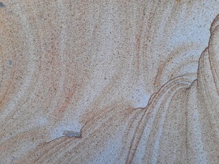Natural sandstone texture with soft beige and brown wavy patterns, perfect for backgrounds and...