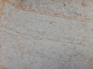 Natural sandstone texture with soft beige and brown wavy patterns, perfect for backgrounds and design.