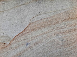 Natural sandstone texture with soft beige and brown wavy patterns, perfect for backgrounds and...