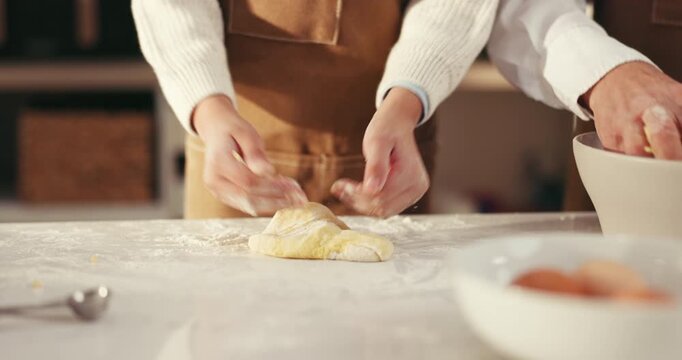 Hands, parent and kid with baking dough in kitchen for cookies snack, learning and development. Family, people and child kneading ingredients in home for culinary skills, helping and teaching recipe