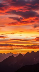 Fiery Sunset Over Mountain Peaks: Dramatic Sky and Silhouette Landscape