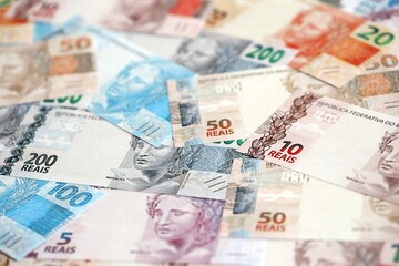 Brazilian reais banknotes. The current Brazil real money bills lies on table in big amount
