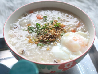 Delicious egg porridge in a ceramic cup