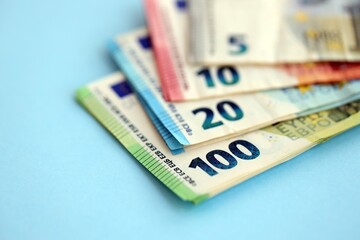 Big amount of european euro currency money notes on blue color table close up