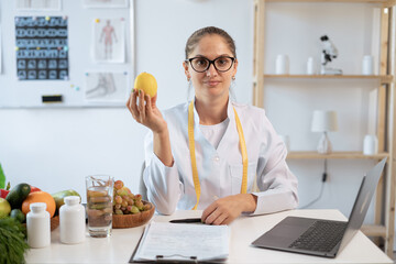 Healthy food, right nutrition and diet. Young caucasian nutritionist giving consultation to patient...